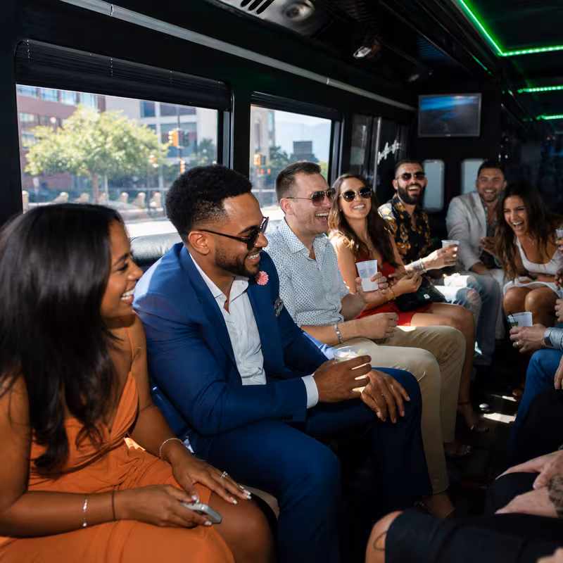 Party bus interior with wraparound leather seating and LED lighting in Colorado Springs