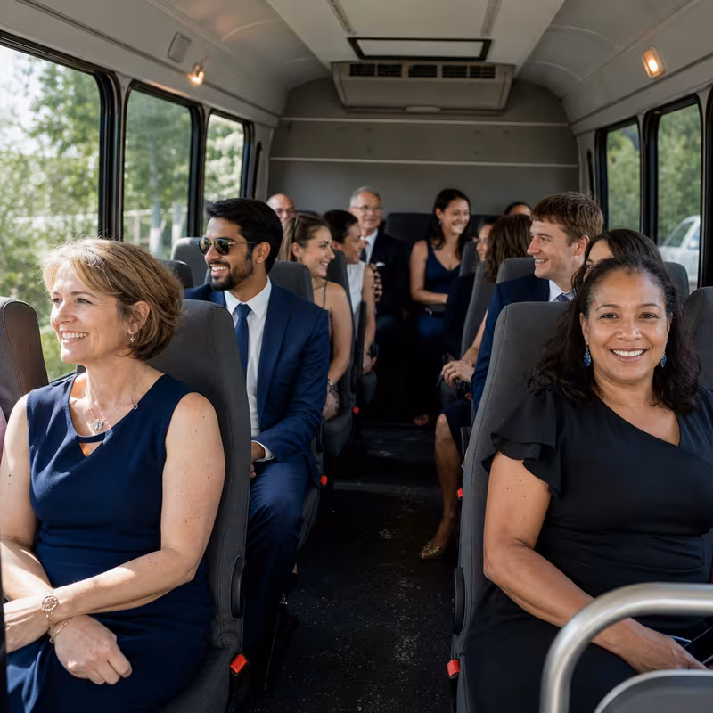 Group boarding a white charter bus for Private Event Transportation transportation in Colorado Springs