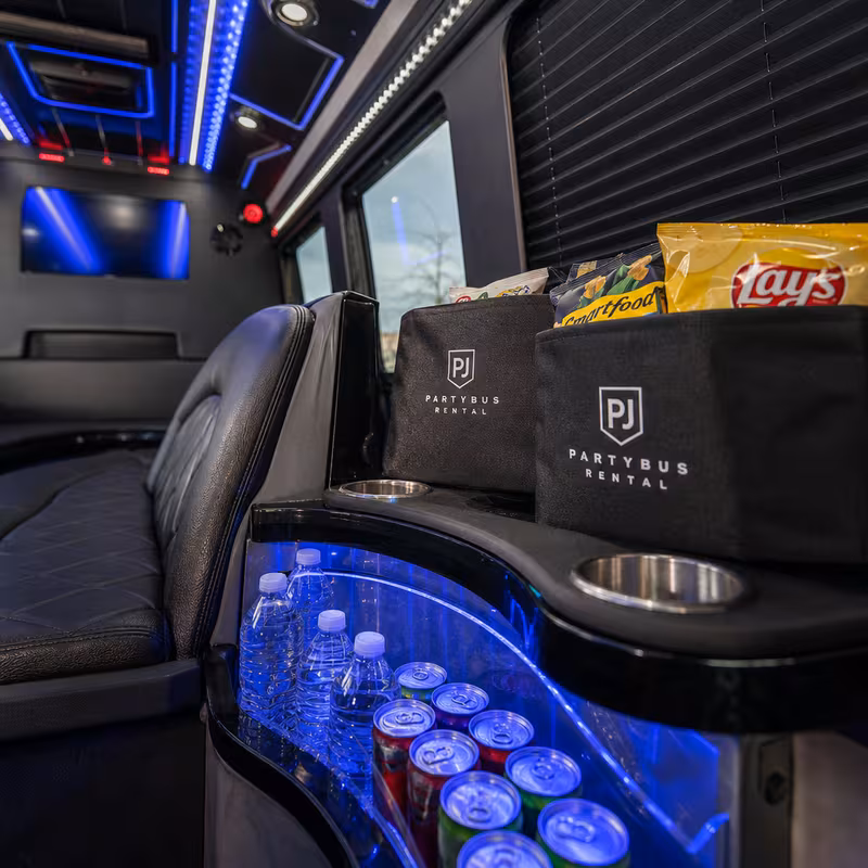 Party bus interior with wraparound leather seating and LED lighting in Colorado Springs